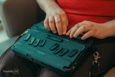 Close up shot of someone typing on a braille notetaker.