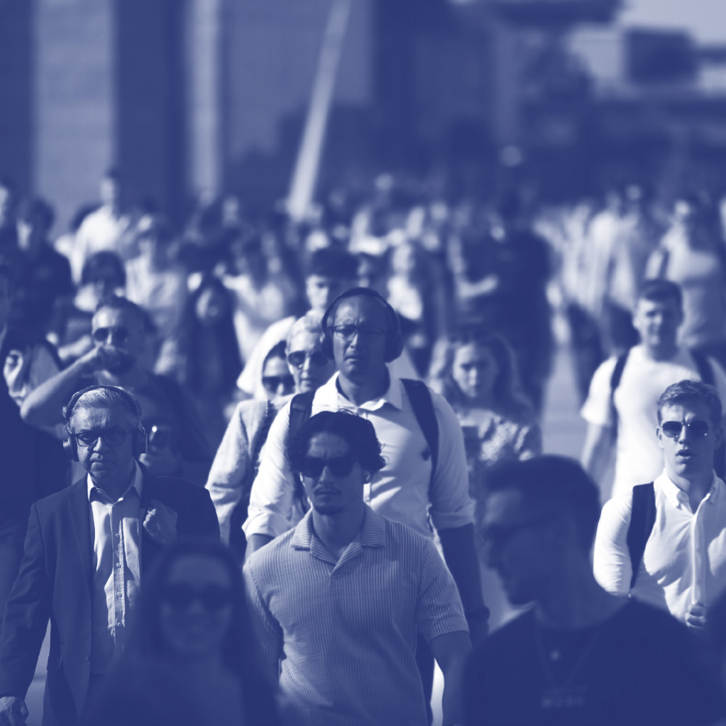 TR Report Cover-blue Large group of people walking in one direction outside.